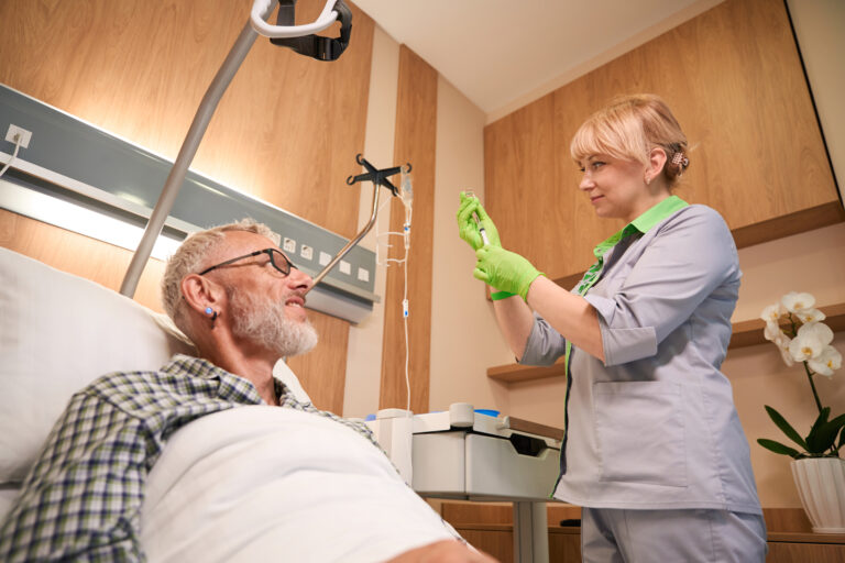 Experienced nurse draws medicine into a syringe