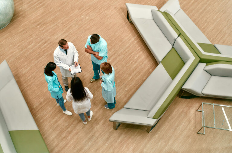 Top view of a team of doctors who stand in the lobby of a modern