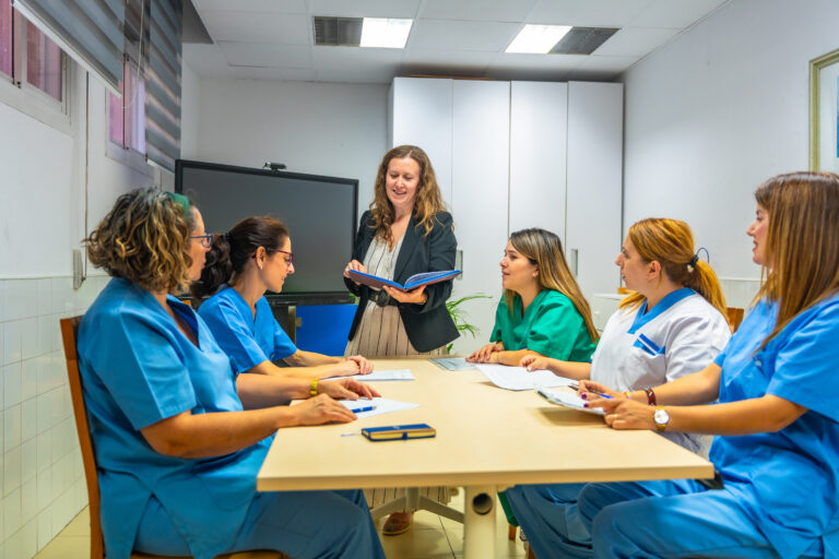 Team of health workers sitting meeting room in geriatrics